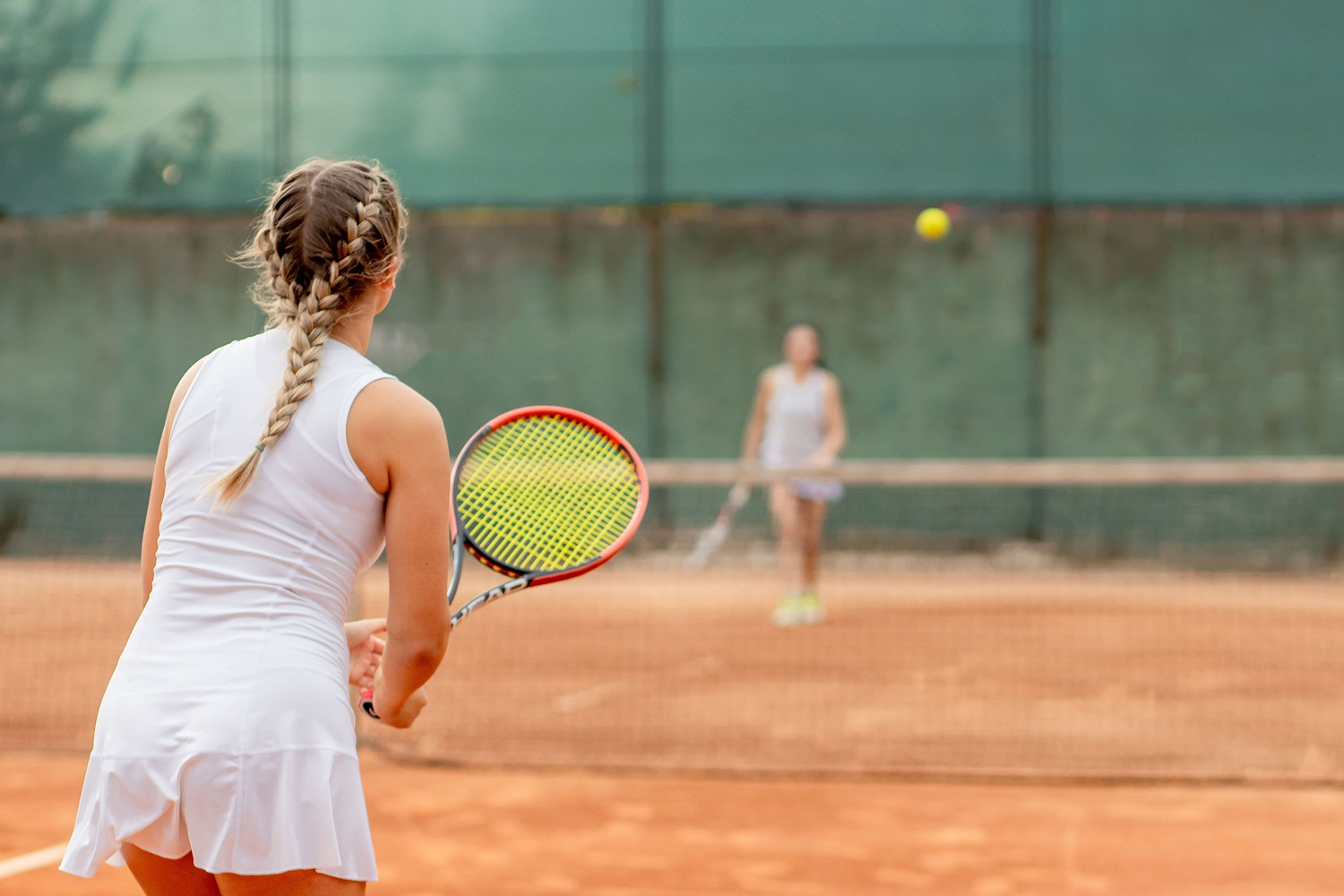 Professional tennis player playing tennis on a clay tennis c