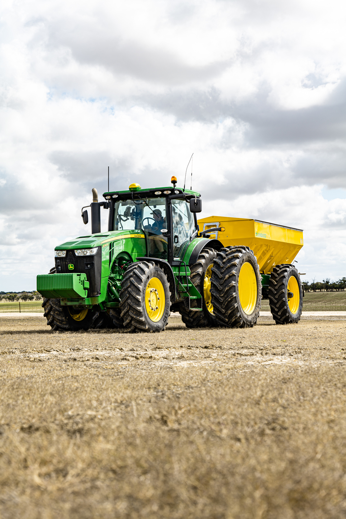 Tractor sowing grain on agricultural field